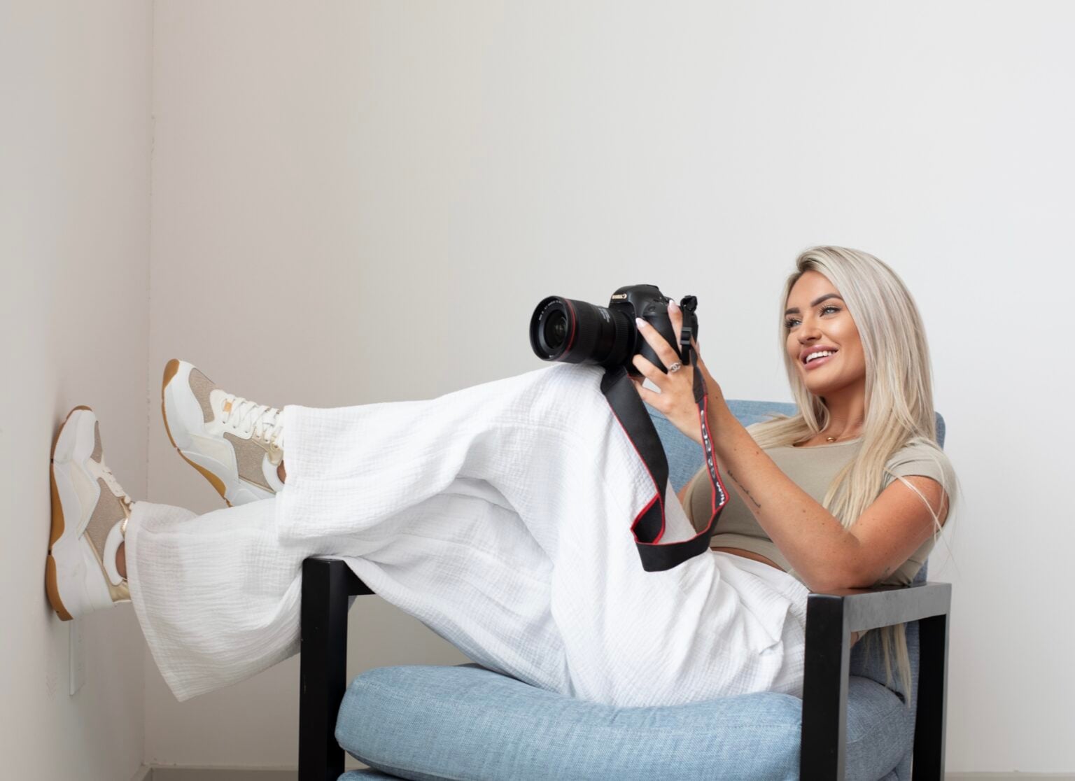 Kayce Sadler, founder of Abode Marketing, reviewing photos on her camera