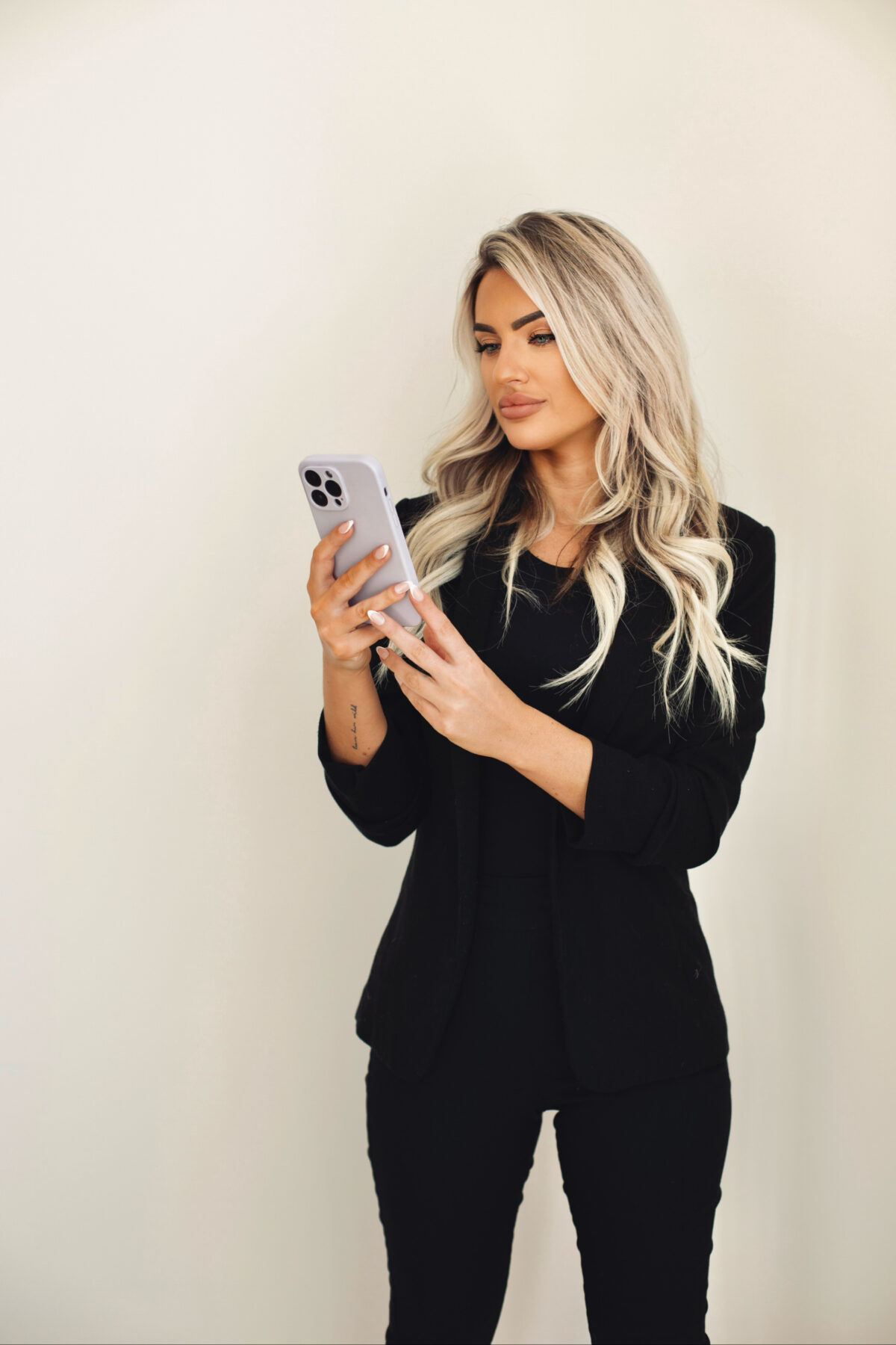 Kayce Sadler, founder of Abode Marketing, on her phone