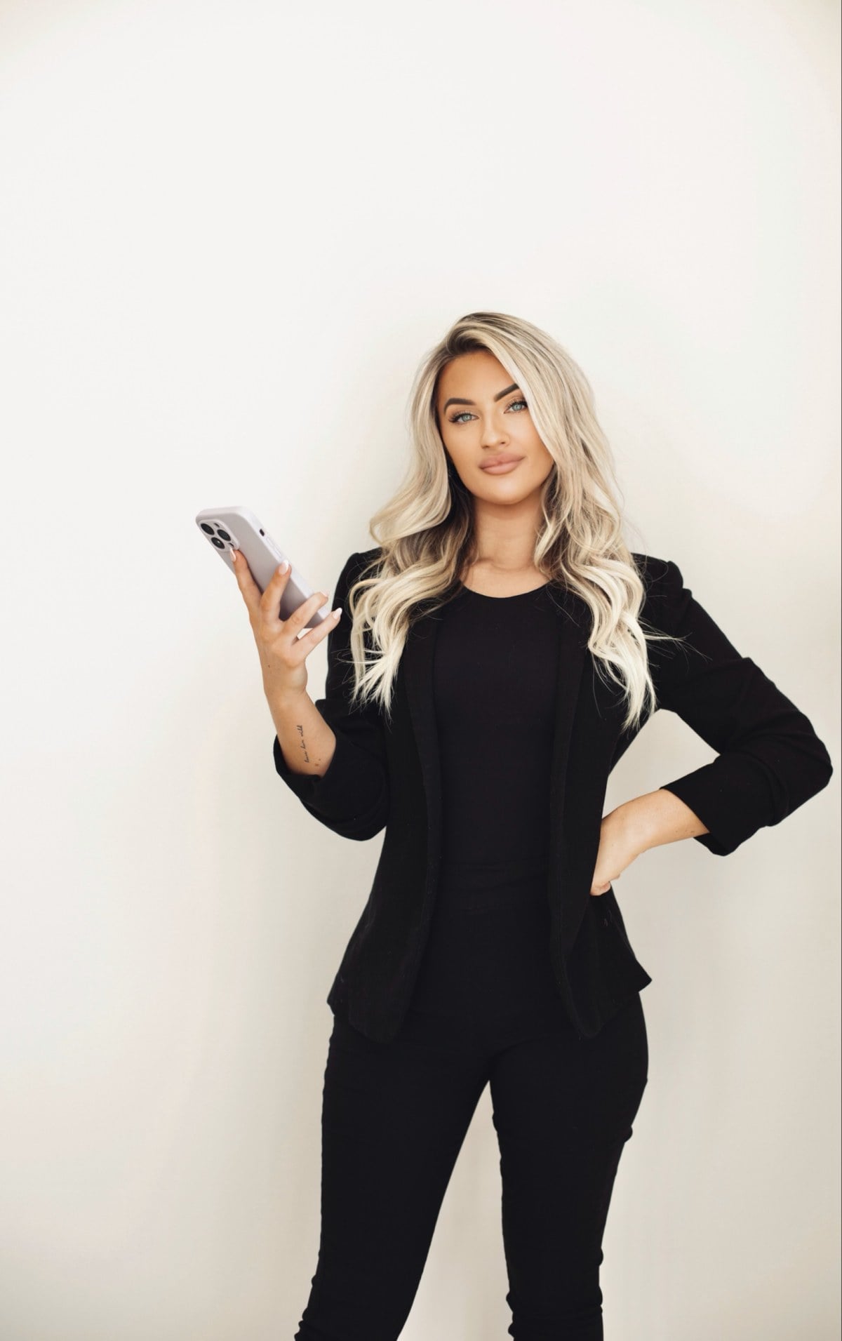 Kayce Sadler, founder of Abode Marketing, with her laptop