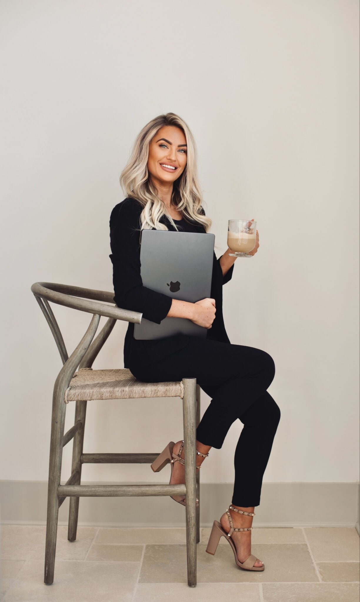 Kayce Sadler, founder of Abode Marketing, working at her laptop