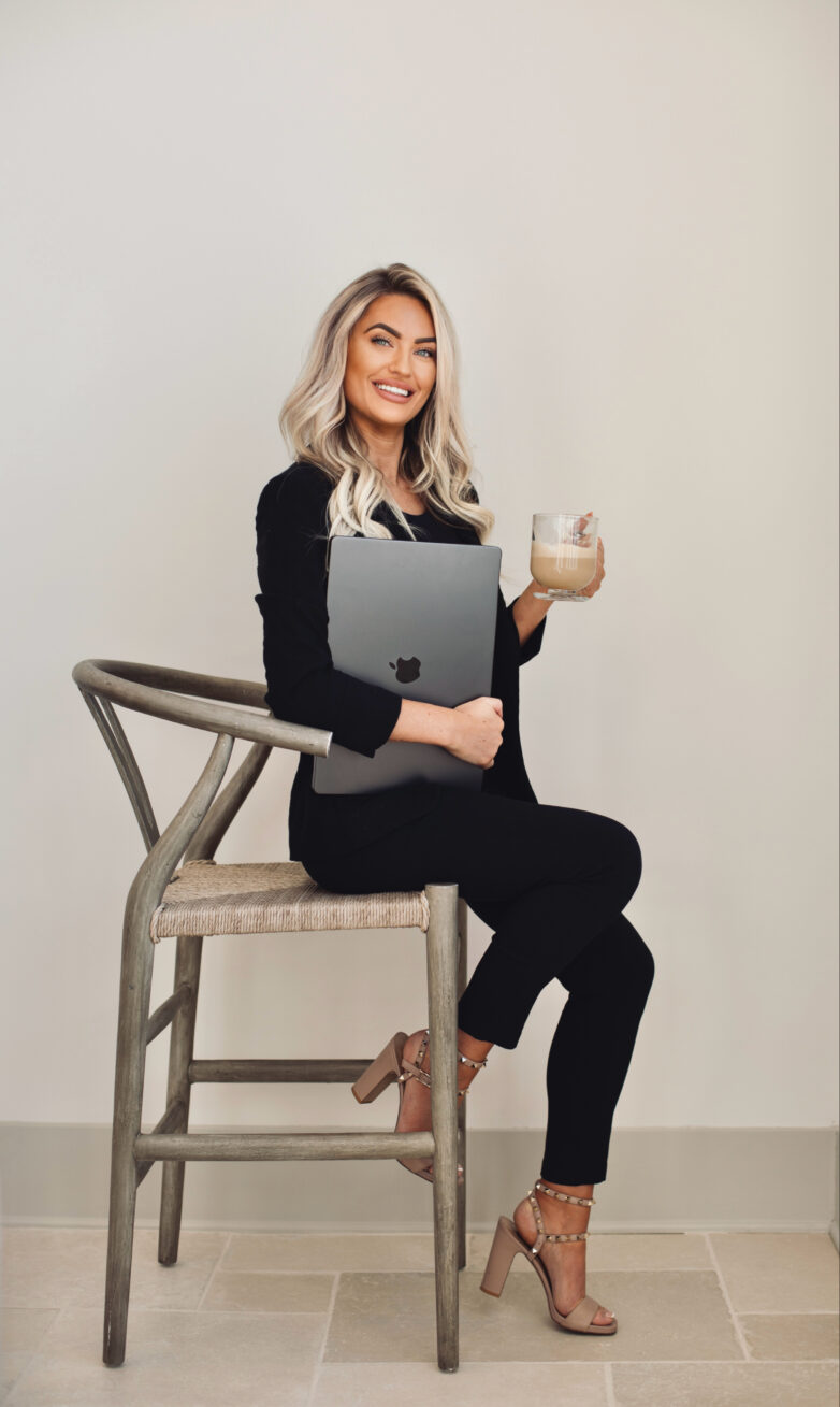 Kayce Sadler, founder of Abode Marketing, with her laptop and coffee