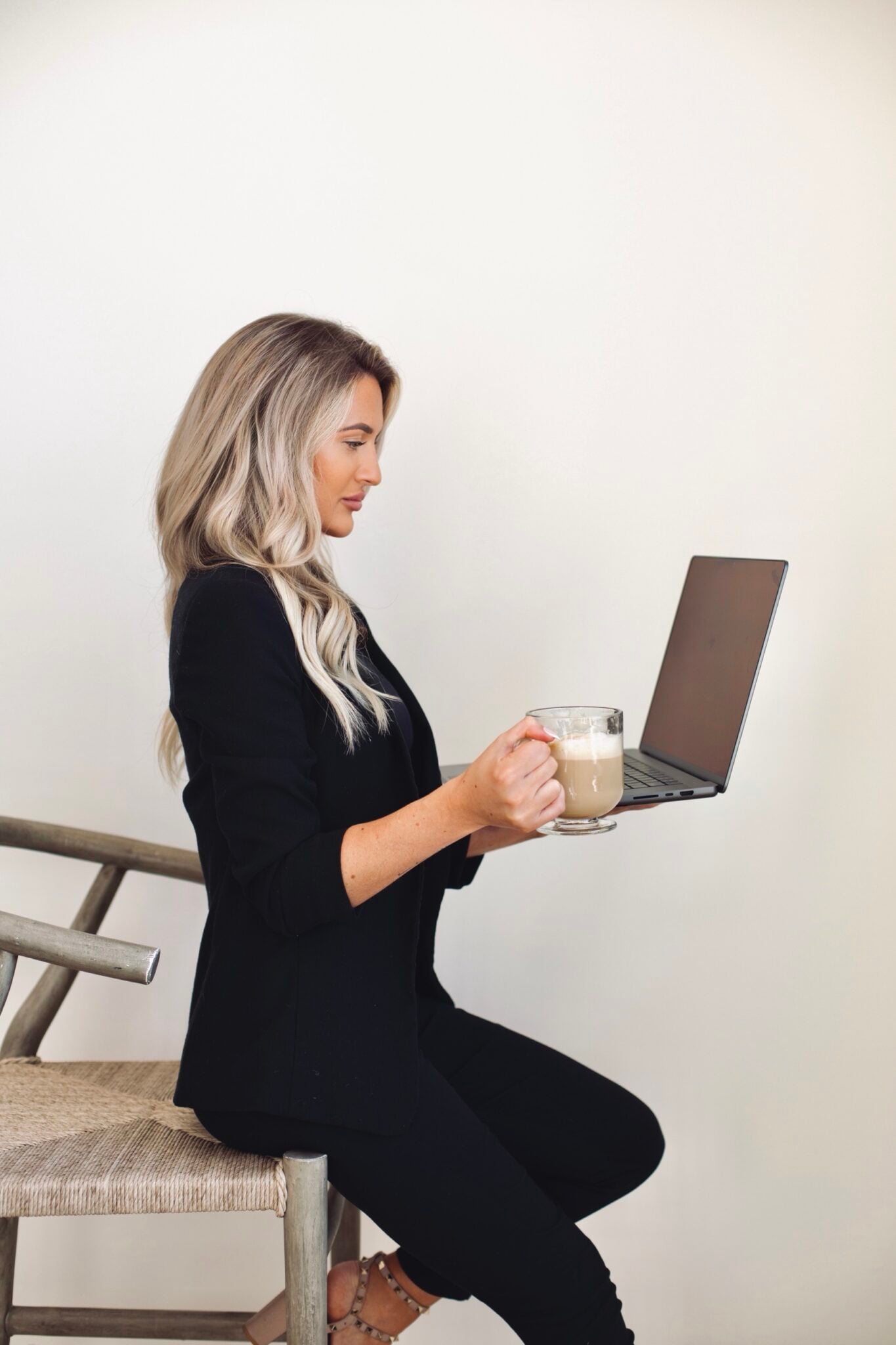 Kayce Sadler, founder of Abode Marketing, with her laptop