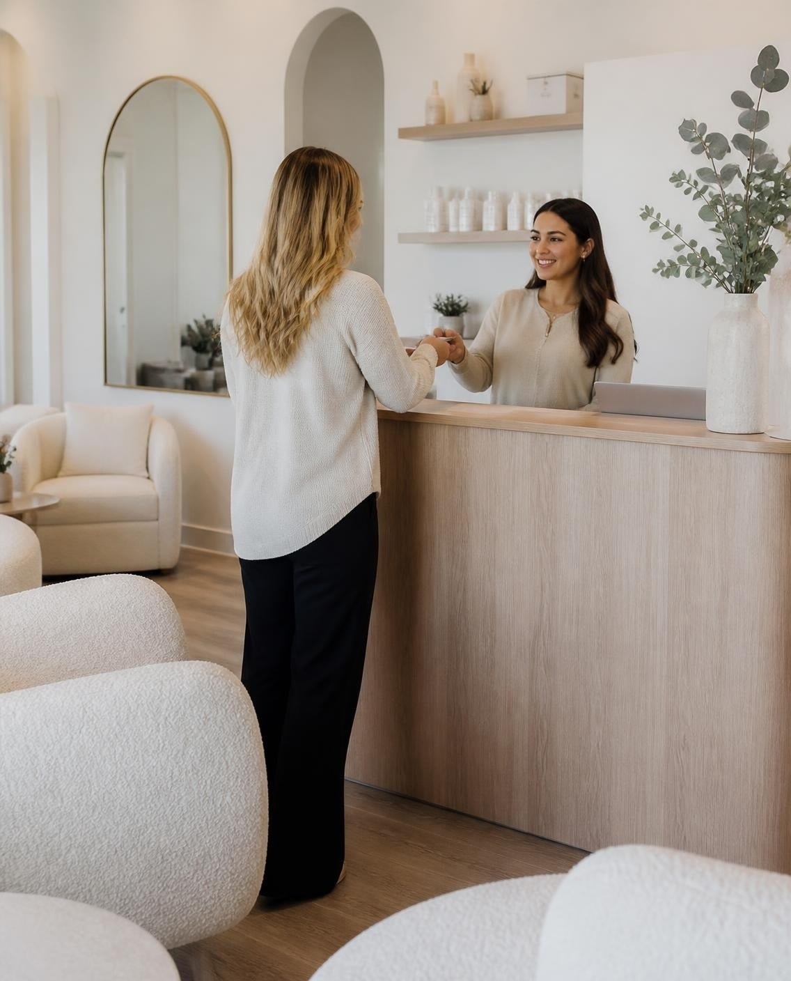 Med spa front desk team welcoming a client
